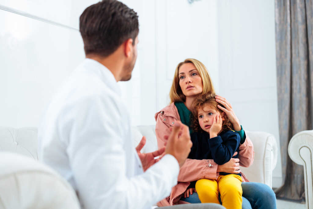Scared child at dentist waiting room.