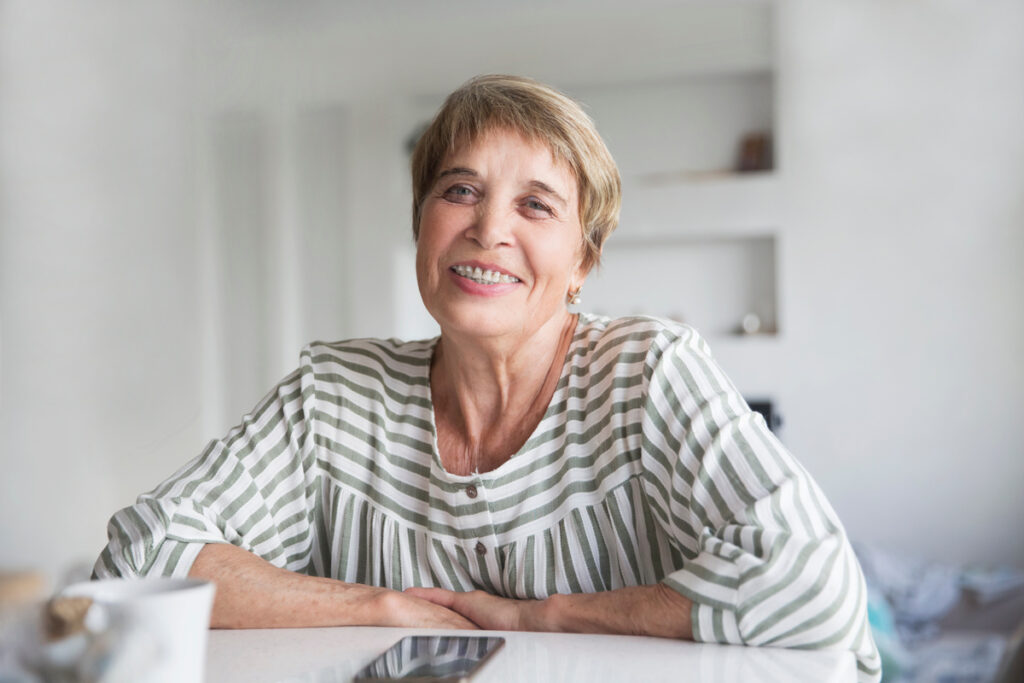 Portrait of positive senior woman with dental braces posing indoors. Copy space. elderly woman smile with Brackets .
