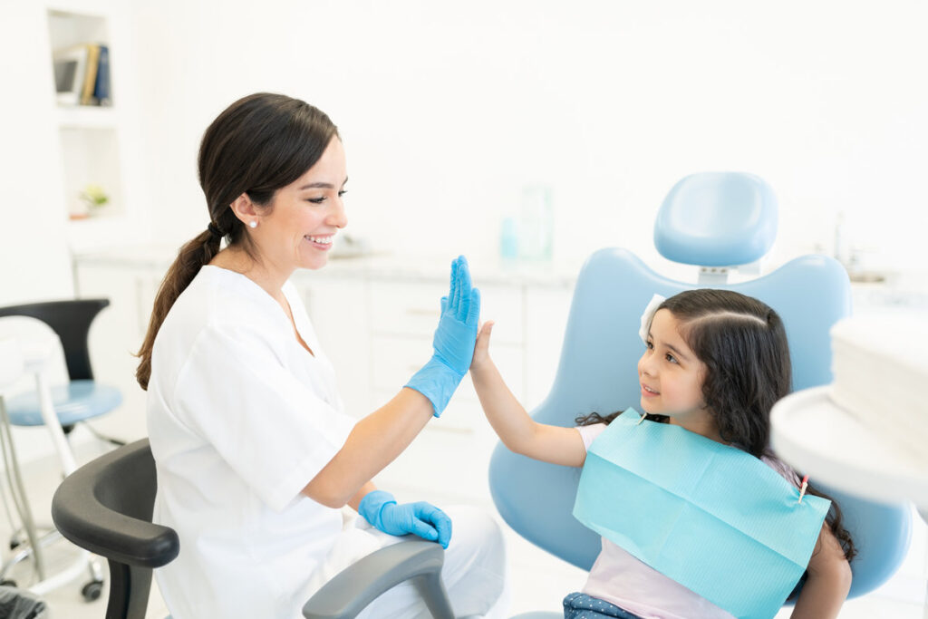 Smiling Dentist And Patient High-Fiving