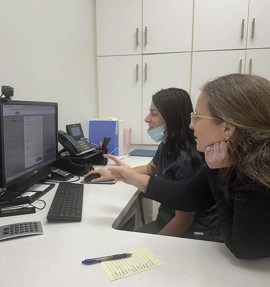 staff at desk looking at computer