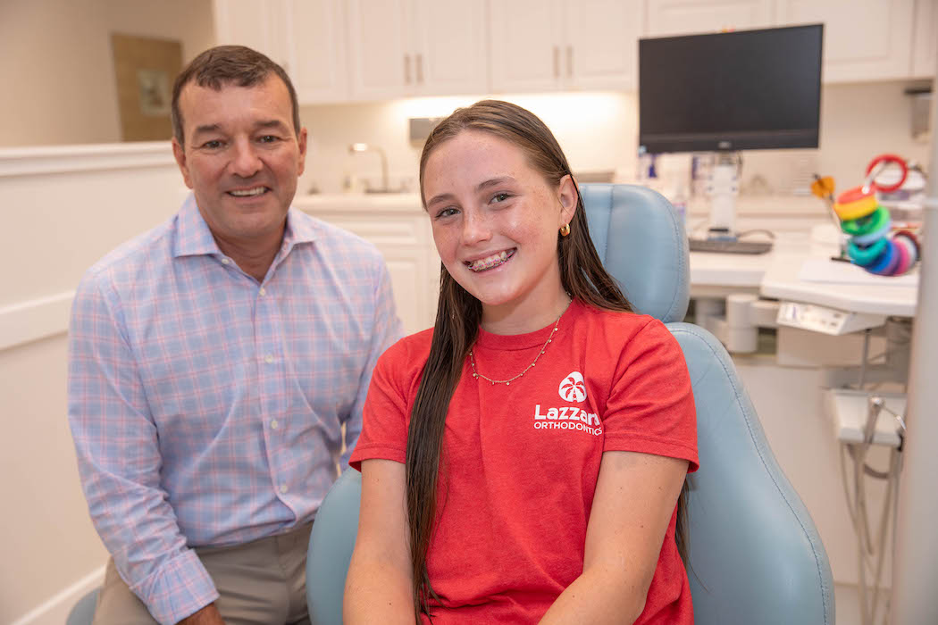 Teen girl patient and Dr. Lazzara in exam chair smiling