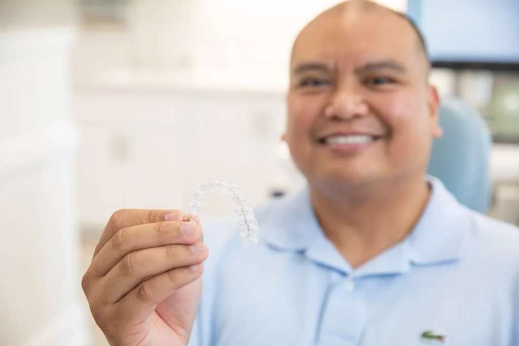 man holding clear retainer