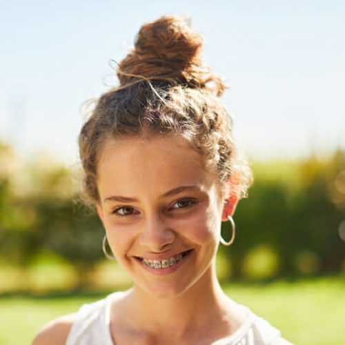 Teenager outdoors smiling at camera. Family lifestyle in Buenos Aires