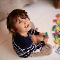 I’ve got my ABC’s covered Portrait of an adorable little boy playing with colorful toy letters